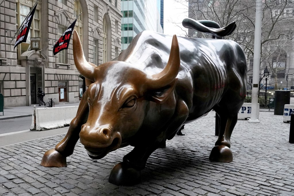 Charging Bull sculpture on a street in New York City.