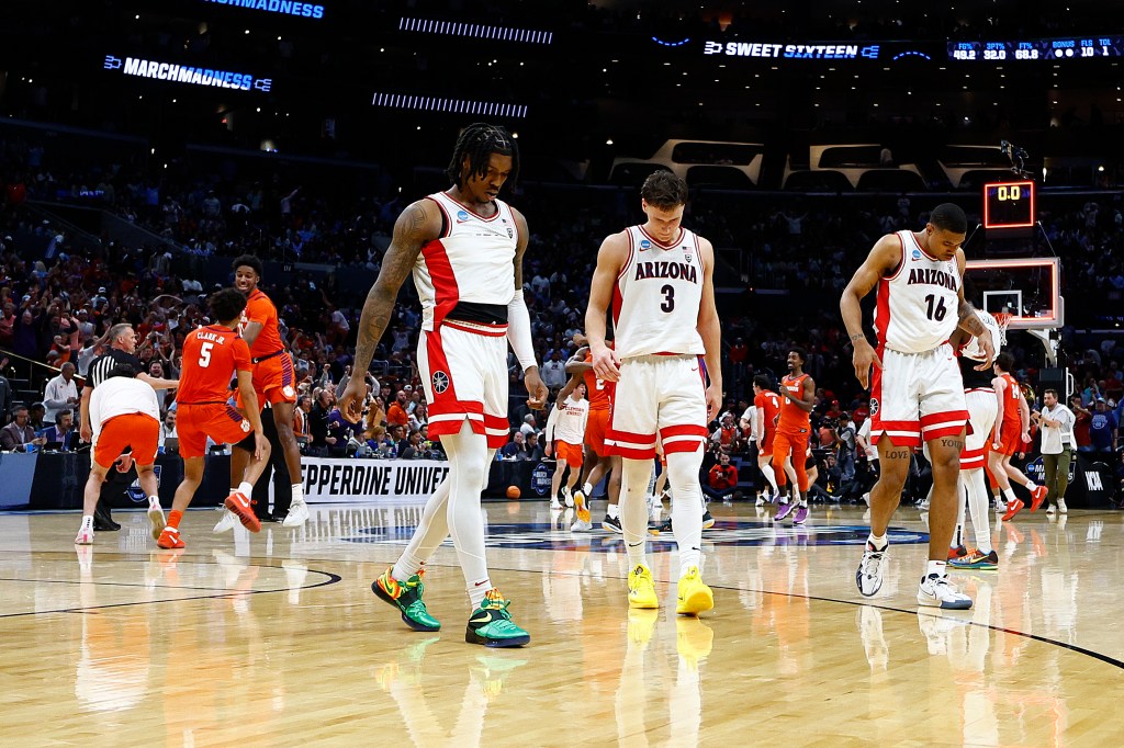 Caleb Love #2, Pelle Larsson #3 and Keshad Johnson #16 of the Arizona Wildcats reacts after losing to the Clemson Tigers during the second half in the Sweet 16 round of the NCAA Men's Basketball Tournament at Crypto.com Arena on March 28, 2024