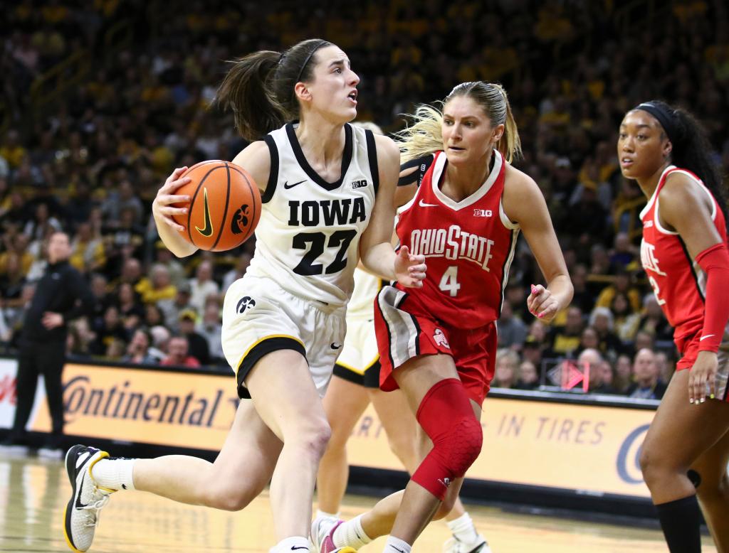 Caitlin Clark #22 of the Iowa Hawkeyes goes to the basket during the second half against guard Jacy Sheldon #4 the Ohio State Buckeyes at Carver-Hawkeye Arena.