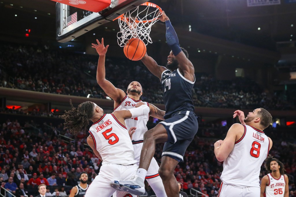 Supreme Cook (24) dunks past St. John's Red Storm guard Daniss Jenkins (5) at Madison Square Garden.