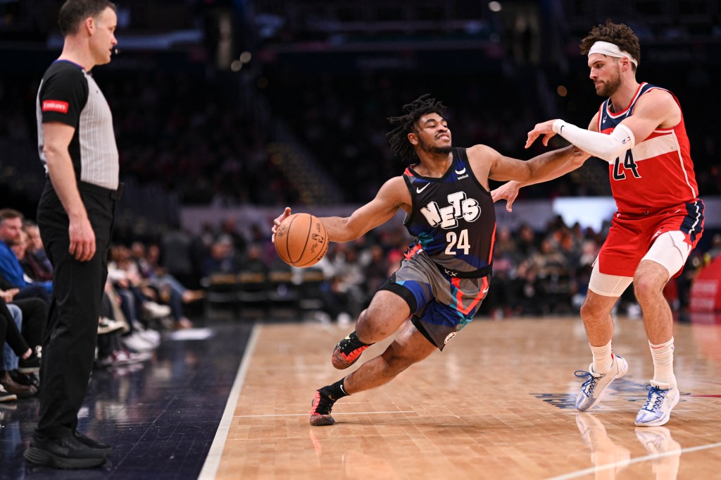 Nets guard Cam Thomas (24) makes a move to the basket as Washington Wizards forward Corey Kispert defends.