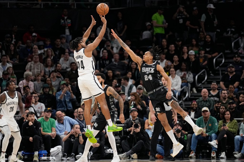 Nets guard Cameron Thomas (24) shoots over San Antonio Spurs guard Devin Vassell (24) during the first half at Moody Center.