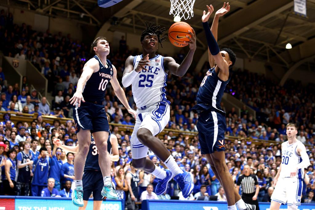 Mark Mitchell goes to the basket against Taine Murray #10 and Ryan Dunn #13 of the Virginia Cavaliers during the second half of the game at Cameron Indoor Stadium.