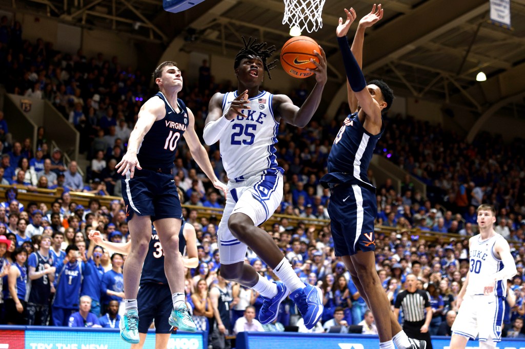 Mark Mitchell goes to the basket against Taine Murray #10 and Ryan Dunn #13 of the Virginia Cavaliers during the second half of the game at Cameron Indoor Stadium.