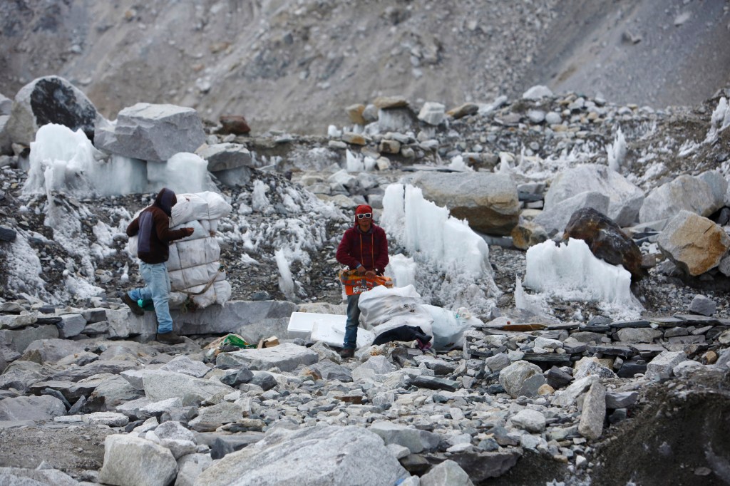 Garbage collectors pick up trash deserted at the Everest base camp on May 6, 2014.