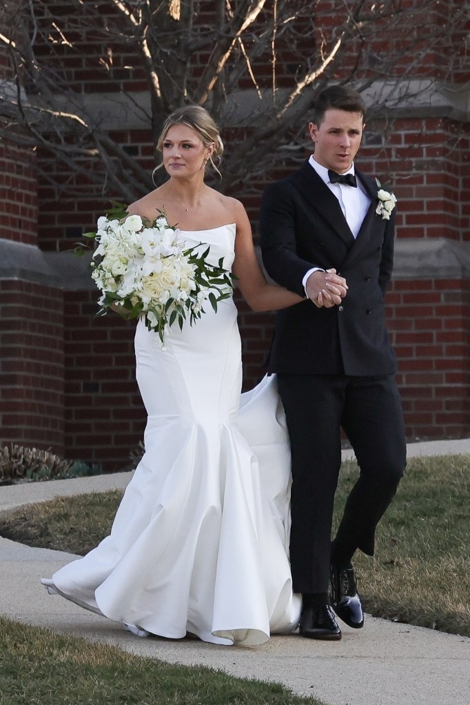 The new Mrs. could be seen holding a beautiful bouquet of white flowers.