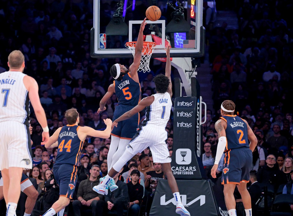 Precious Achiuwa #5 jumps to block Jonathan Isaac #1 of the Orlando Magic during the first quarter.