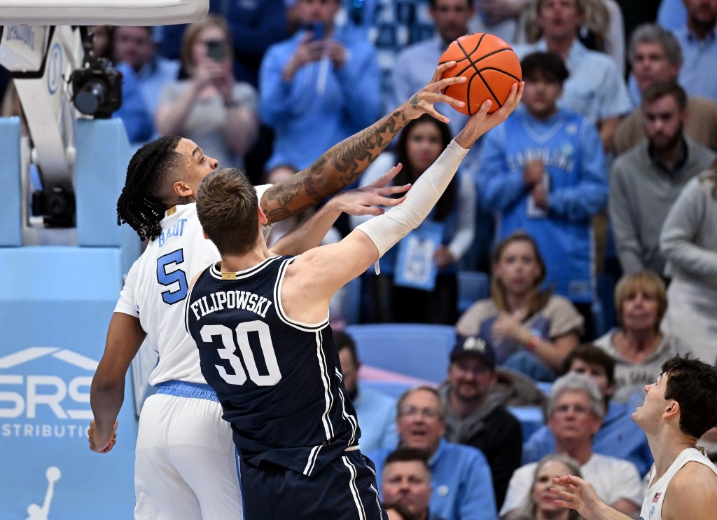 Armando Bacot blocks Kyle Filipowski in the first matchup.