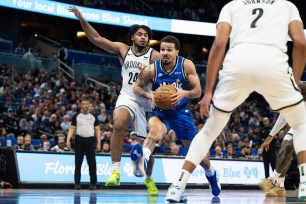 Magic guard Cole Anthony (50) drives to the basket against Brooklyn Nets guard Cam Thomas (24) in the fourth quarter.