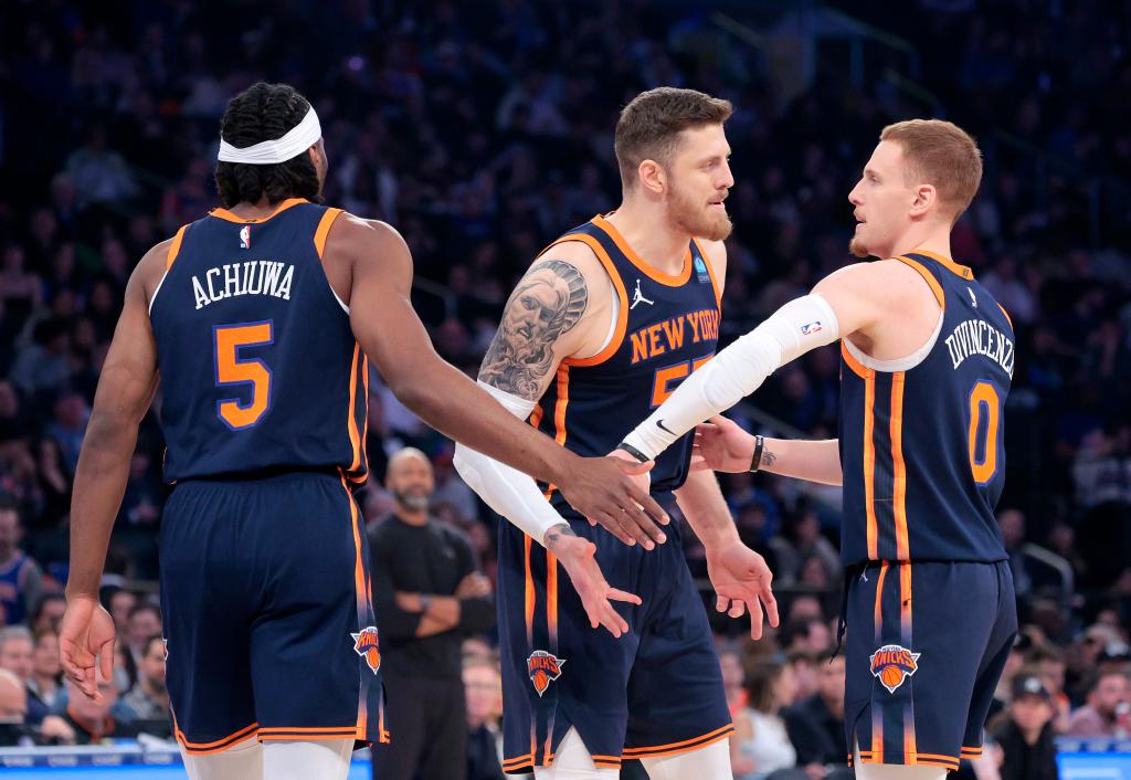 Isaiah Hartenstein greets Precious Achiuwa #5 of the New York Knicks and Donte DiVincenzo #0 of the New York Knicks during the first quarter.