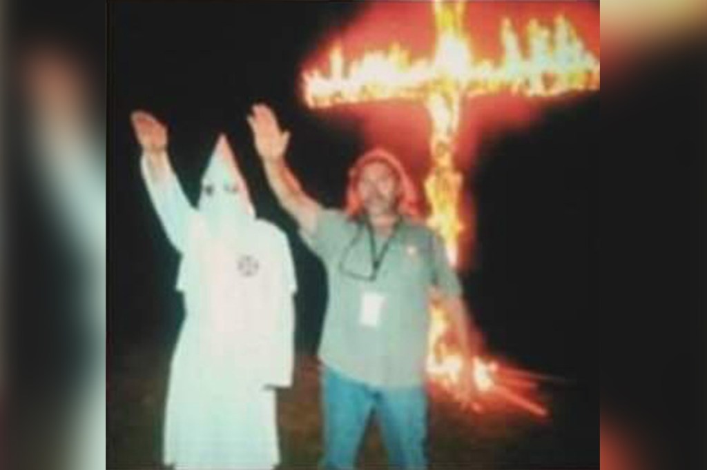 A photo from 2019 appears to show McClanahan at a cross burning giving a Nazi salute next to a man dressed in full KKK regalia.