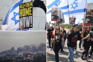 People holding signs and flags during a four-day march by families of hostages held by Hamas towards Jerusalem from Gaza Border in Israel.