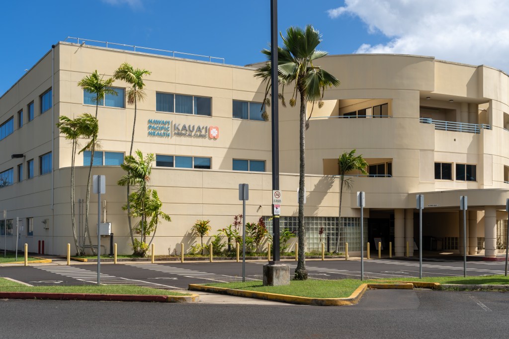 Hawaii Pacific Health Wilcox Medical Center building with palm trees and a street light at Lihue, Hawaii, USA on January 28, 2024.