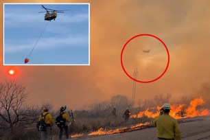 a helicopter flying over a fire