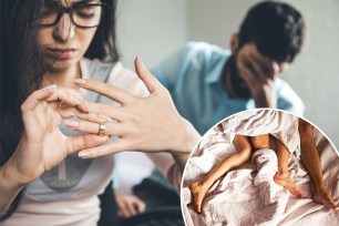 a woman looking at a ring on her hand