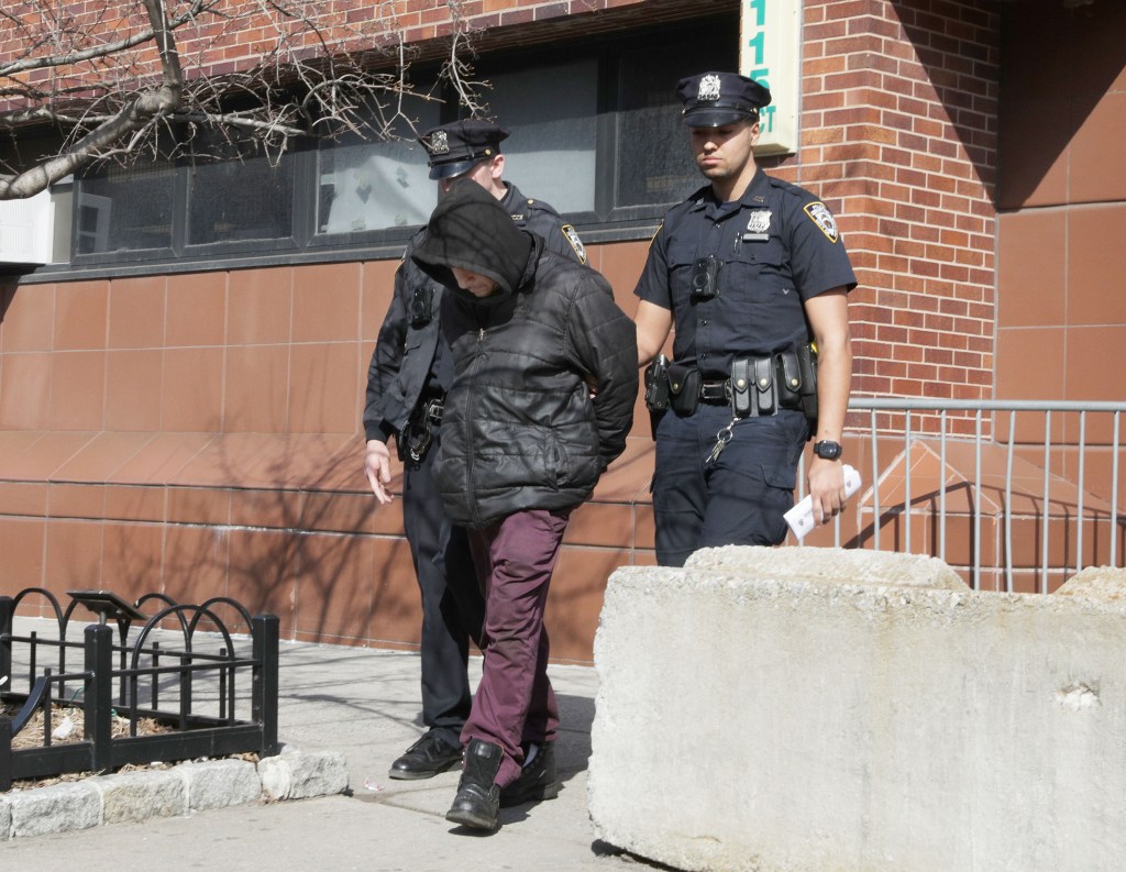 Police walking suspect Jose Barcia out of the 115th precinct in Queens.