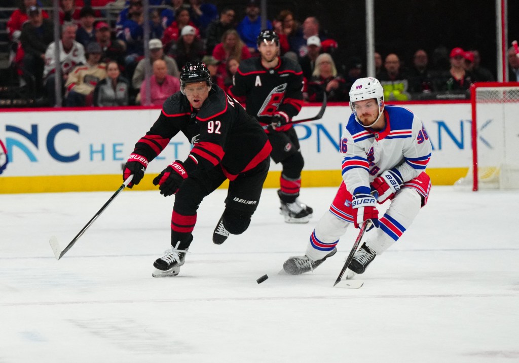 Carolina Hurricanes center Evgeny Kuznetsov (92) and New York Rangers center Jack Roslovic (96) battle over the puck during the third period at PNC Arena.