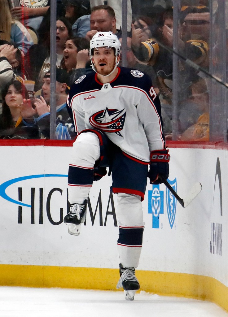 Jack Roslovic of the Columbus Blue Jackets in blue uniform and white helmet, reacting after scoring a goal against the Pittsburgh Penguins.