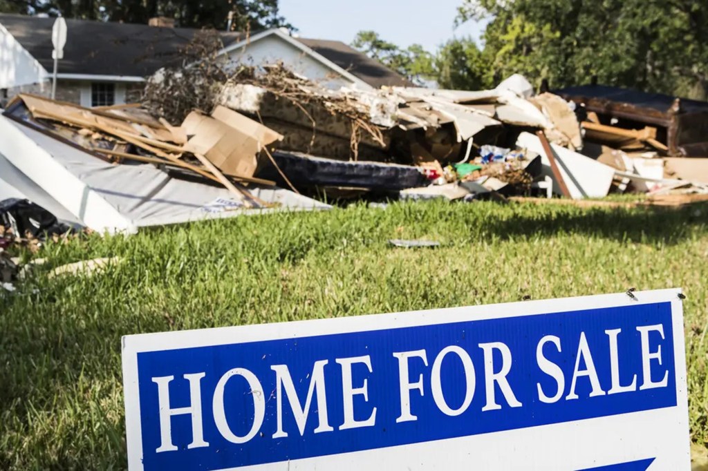 A sign in front of a house