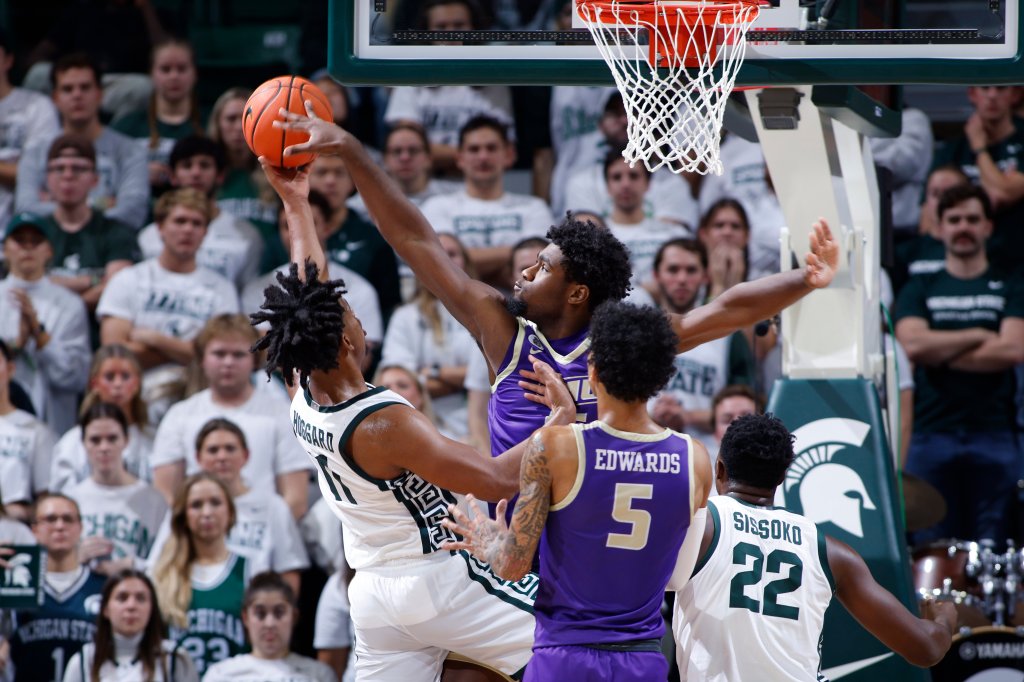 James Madison's Jaylen Carey, center, blocks a shot by Michigan State's A.J. Hoggard, left, as James Madison's Terrence Edwards Jr. (5) and Michigan State's Mady Sissoko (22) watch during an NCAA college basketball game, Monday, Nov. 6, 2023, in East Lansing, Mich. 