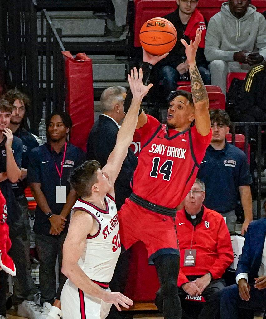 Stony Brook's Tyler Stephenson-Moore shoots over St. John's Sean Conway during the first half of an NCAA college basketball game in New York, Tuesday, Nov. 7, 2023.