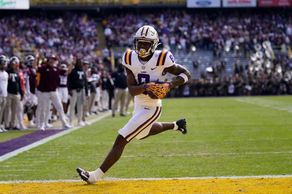 LSU wide receiver Malik Nabers (8) crosses the goal line for a touchdown on a pass reception in the first half of an NCAA college football game against Texas A&M in Baton Rouge, La., Saturday, Nov. 25, 2023. 