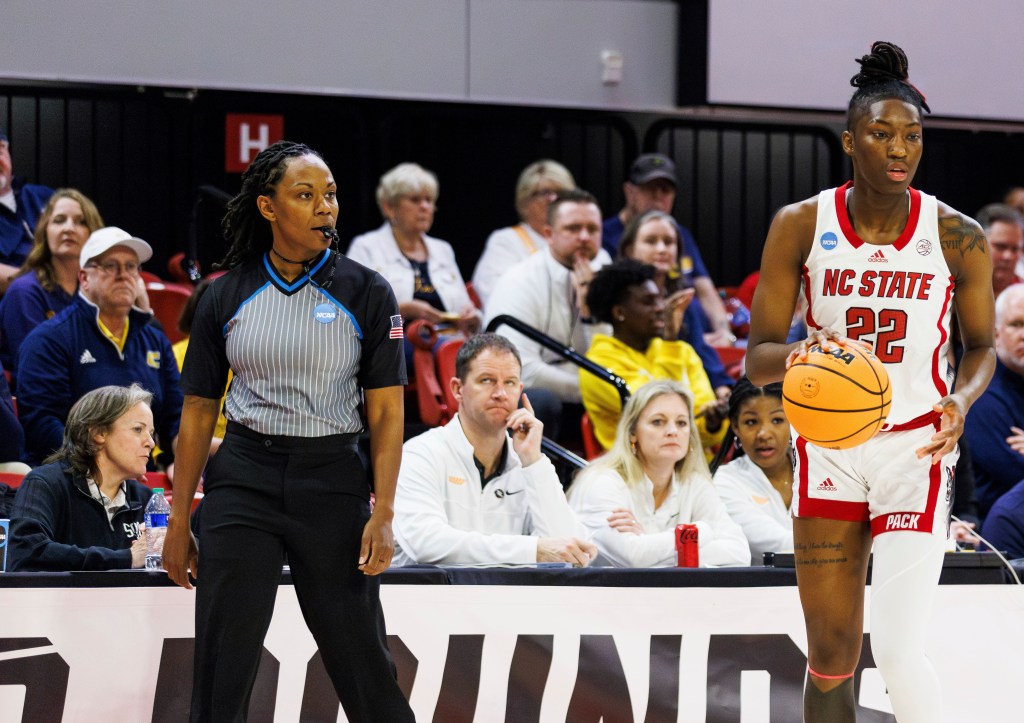 Official Tommi Paris, left, watches as North Carolina State's Saniya Rivers (22) handles the ball during the first half of a first-round college basketball game in the NCAA Tournament in Raleigh, N.C., Saturday, March 23, 2024. 