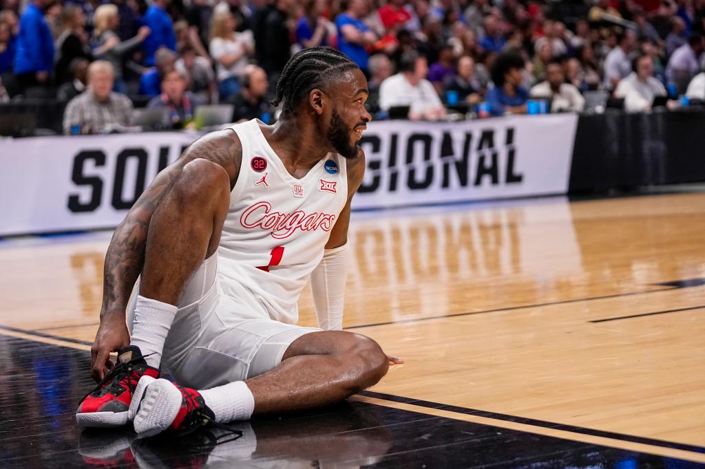 Houston's Jamal Shead reacts after going down while driving.