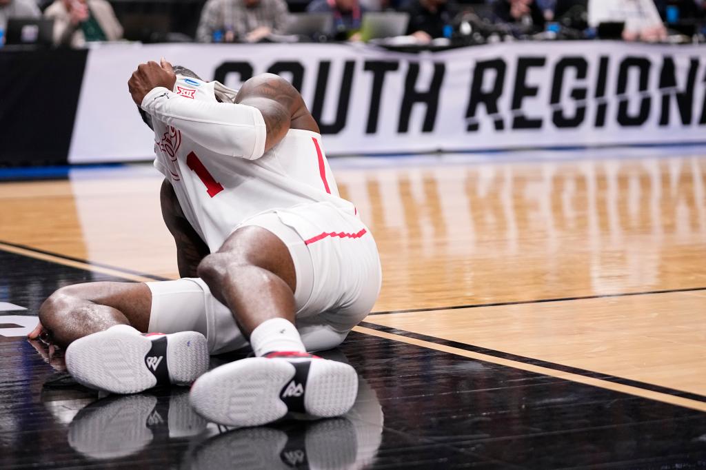 Jamal Shead reacts after suffering an injury during a Sweet 16 game against Duke.
