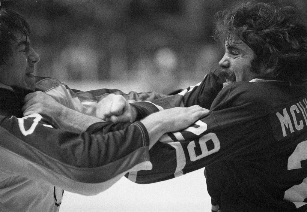 New York Rangers' Nick Fotiu, left, and Vancouver Canucks' Jack Mollhargey clutch each other during fight at their game in New York's Madison Square Garden, Nov. 20, 1977.