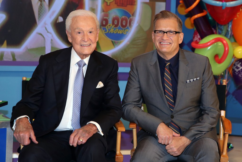 Bob Barker and Drew Carey sitting in chairs on "The Price is Right" set at CBS Studios, Los Angeles. Photo by Matt Sayles/Invision/AP.