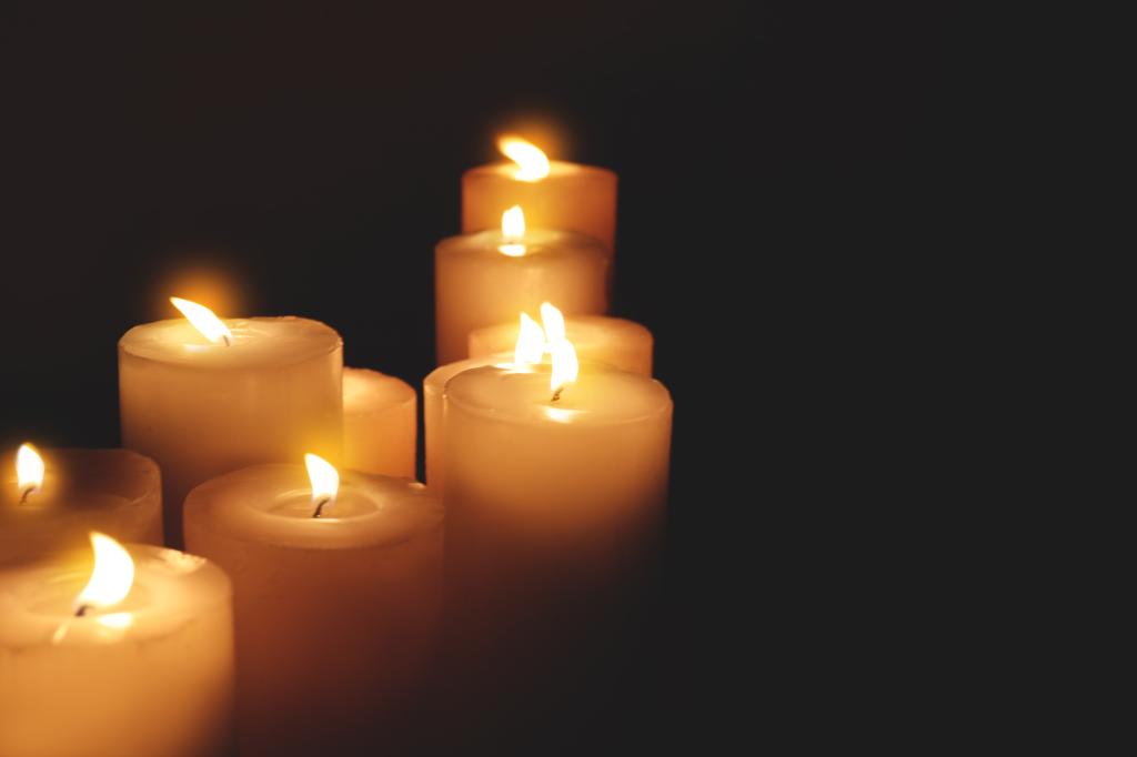 Many burning candles on dark background