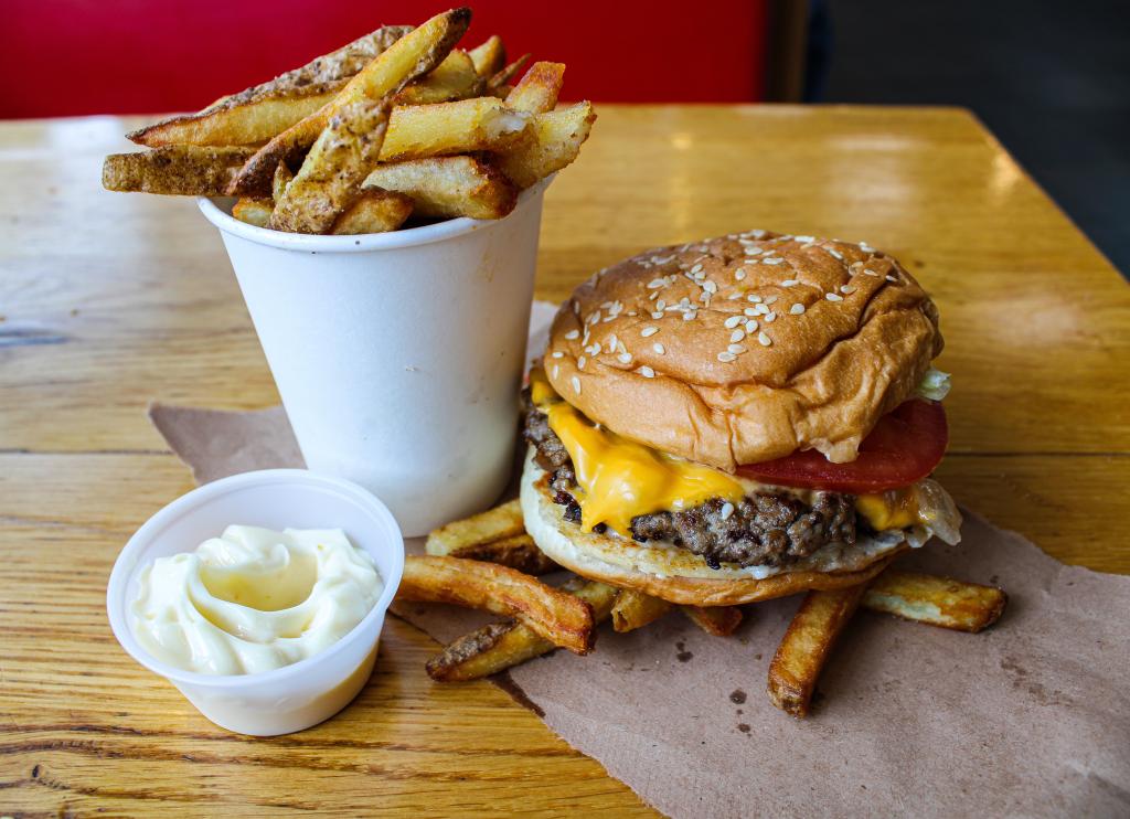 Double cheeseburger and fries on a table from Five Guys