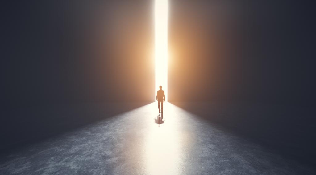 Businessman walking towards an open big gate of light. Concept of hope, new better world, bright future. 3D illustration