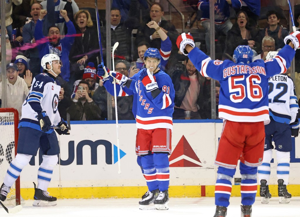 Alex Wennberg  (center) celebrates after scoring his first goal as a Ranger during their 3-2 loss to the Jets. 