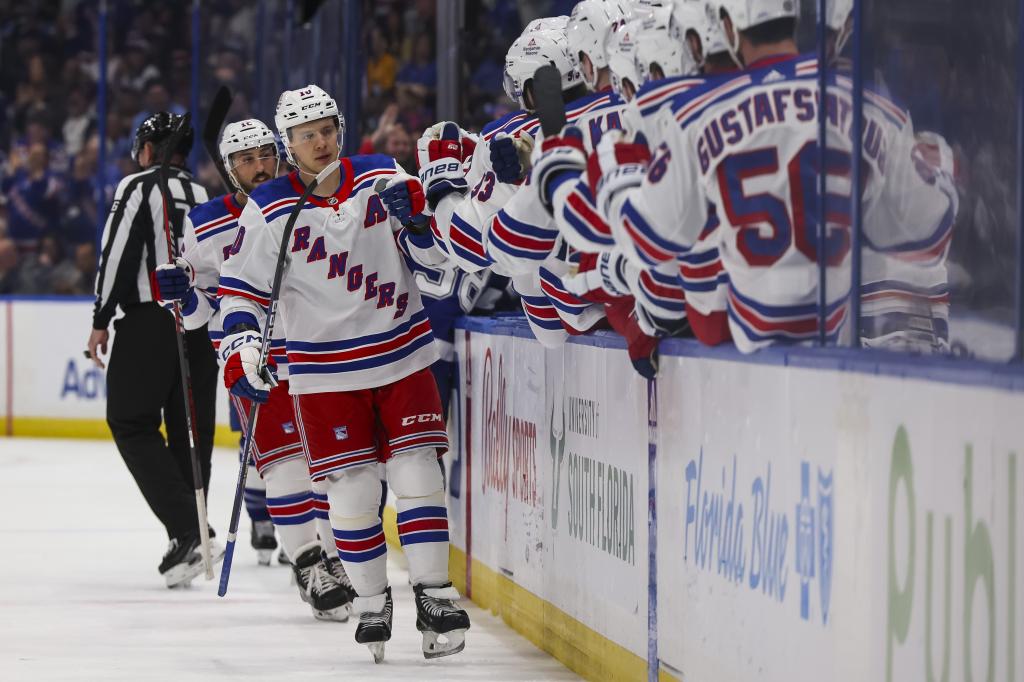 Artemi Panarin celebrates with teammates after scoring a goal during the Rangers' loss.