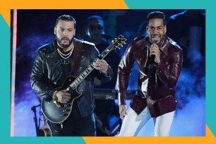 Lenny Santos (L) and Romeo Santos perform together in concert.
