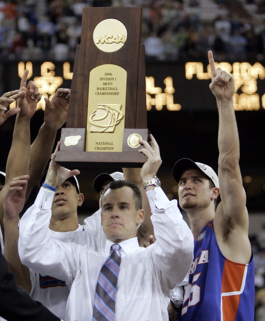 Billy Donovan holds up the national title trophy after Florida's championship win over the Bruins in 2006. They repeated the following year.