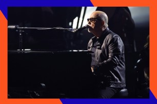 Billy Joel sings while playing piano.