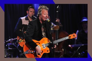 The Stray Cats frontman Brian Setzer rocks out on guitar.