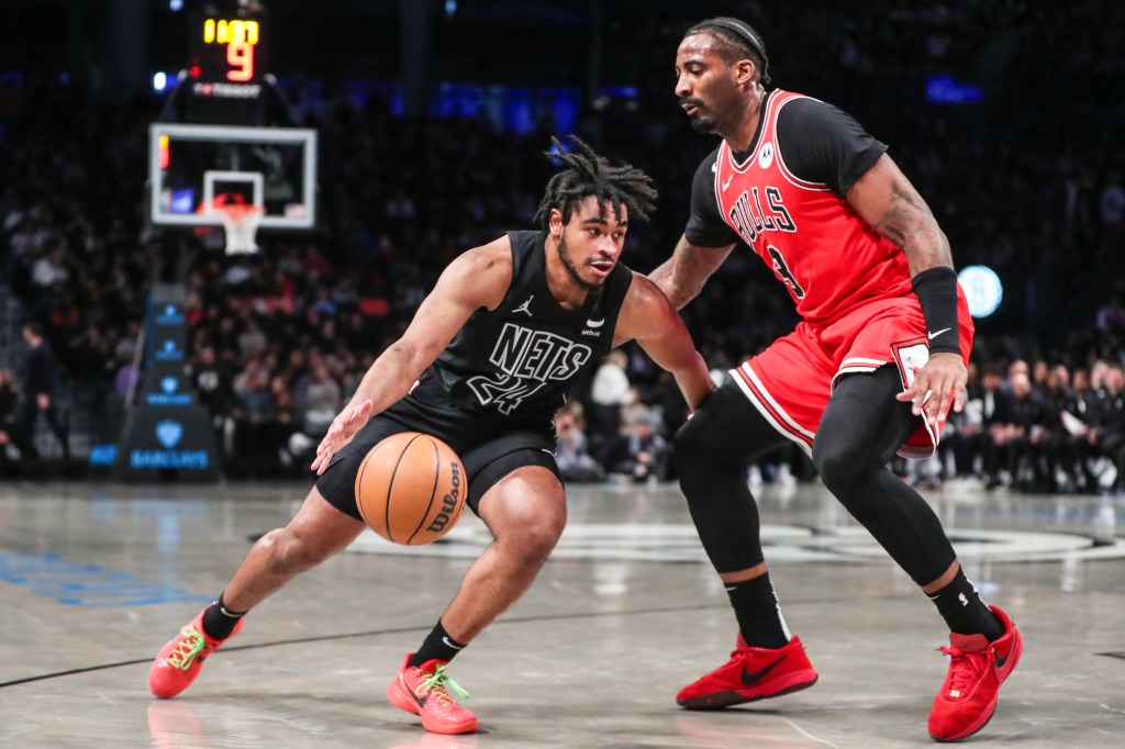 Cam Thomas drives on Andre Drummond during the Nets' victory.