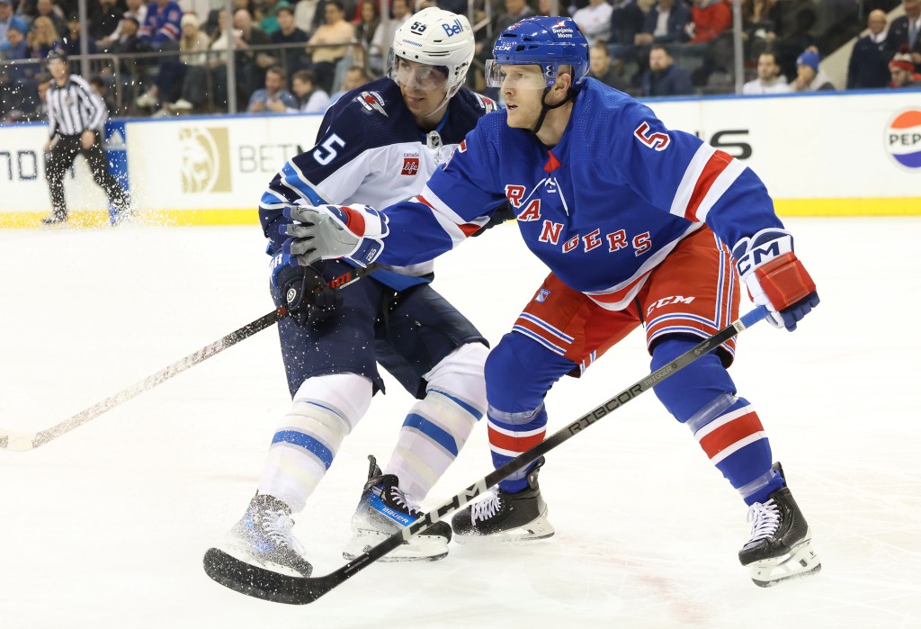 Chad Ruhwedel, who made his Rangers debut, battles Mark Scheifele for the puck during the Rangers' 4-2 loss to the Jets.