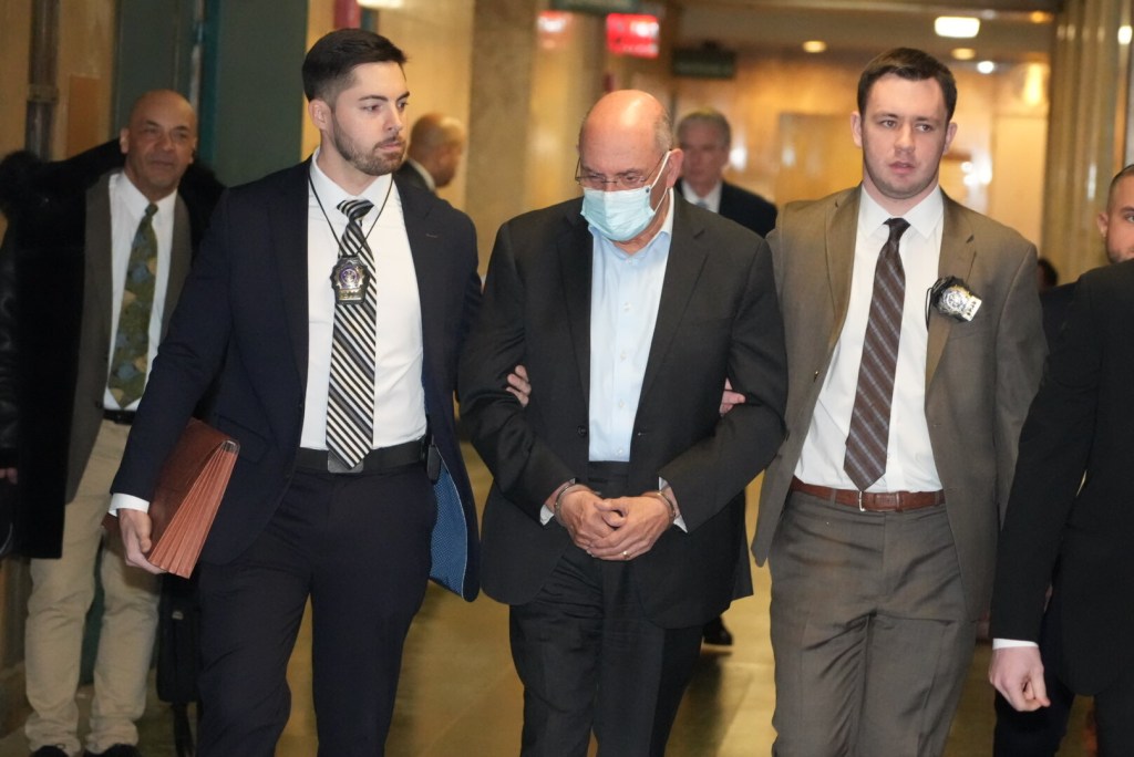 A group of men wearing masks walking down a hallway.