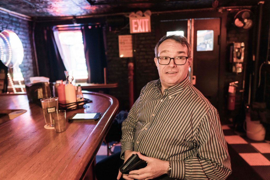 A person sitting at the bar in customer Pubkey, a Manhattan Bitcoin Bar in Greenwich Village Manhattan, New York City.