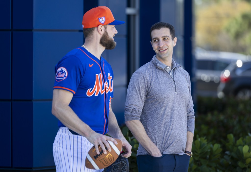 Mets starting pitcher Adrian Houser talks with David Stearns earlier in spring training.