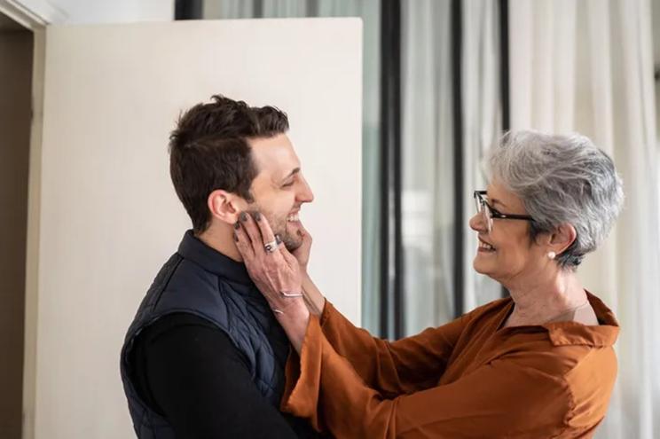 A woman touching a man's face