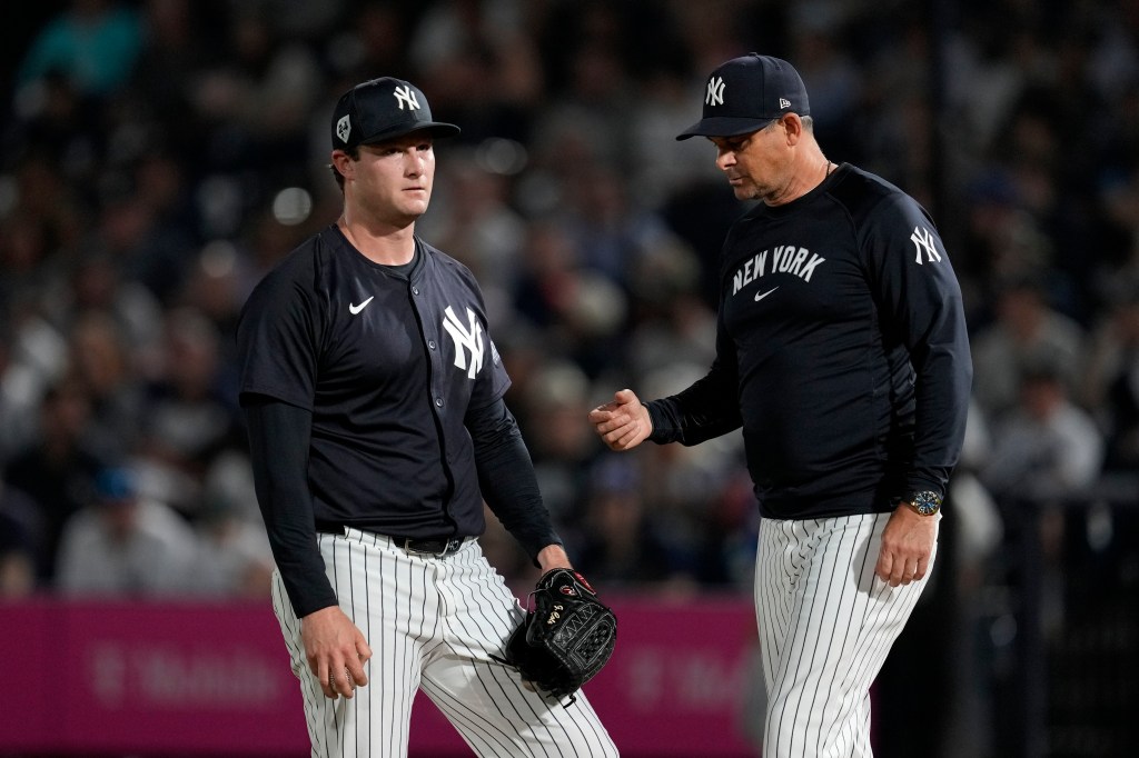 Gerrit Cole, who gave up three runs on four hits, is temporarily taken out of the game by Aaron Boone in the first inning of the Yankees' 8-4 exhibition win over the Blue Jays. But thanks to a spring training rule perk, Cole was able to return to the game in the second inning.