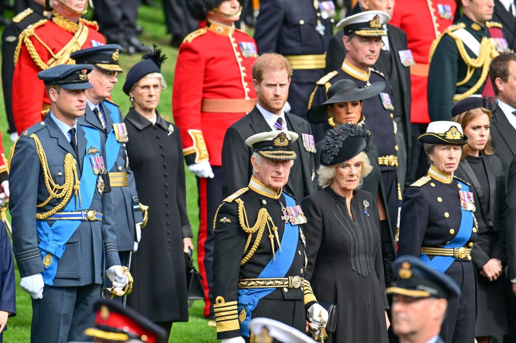 A group of people, including the royals, looking at the coffin of Queen Elizabeth II as it is being transferred from the gun carriage to the hearse.