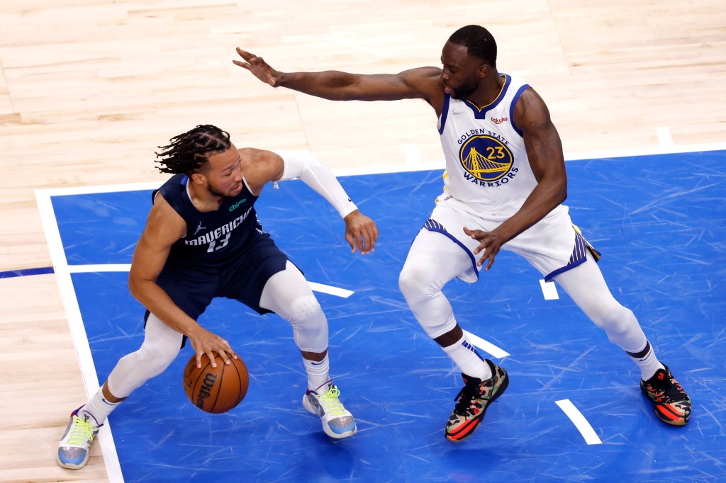 Jalen Brunson #13 of the Dallas Mavericks dribbles against Draymond Green #23 of the Golden State Warriors during the third quarter in Game Three of the 2022 NBA Playoffs Western Conference Finals.