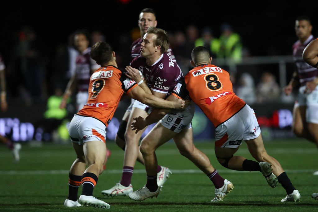 Jake Trbojevic of the Sea Eagles is tackled during the round 27 NRL match between Manly Sea Eagles and Wests Tigers at 4 Pines Park on September 01, 2023